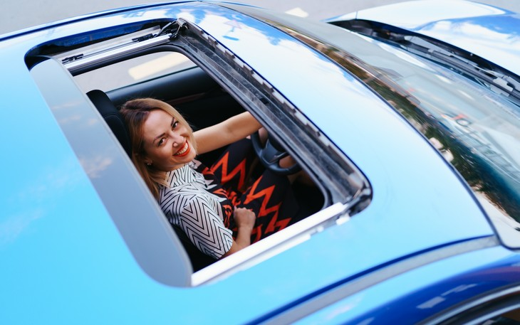 view-of-a-driving-woman-through-sunroof-2023-11-27-05-18-24-utc.webp